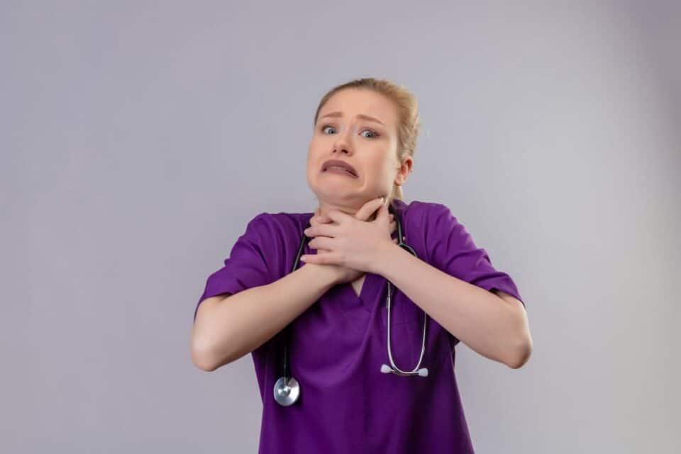 Sudden sore throat and difficulty breathing in a healthcare professional.